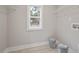 Well-lit laundry area features a window, shelving, and washer/dryer hookups at O Shortline Rd, Roxboro, NC 27574
