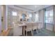 Elegant dining room featuring stylish wallpaper, a round mirror, and a set table at 100 Cloud Berry Ln, Holly Springs, NC 27540