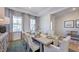 Cozy dining room with tray ceiling, large windows, and decoratively set dining table at 100 Cloud Berry Ln, Holly Springs, NC 27540