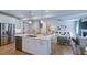 Modern kitchen and living area with stainless steel appliances and hardwood floors at 100 Cloud Berry Ln, Holly Springs, NC 27540