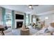 Inviting living room with a fireplace, TV, stylish decor, and an open layout to the dining area at 100 Cloud Berry Ln, Holly Springs, NC 27540