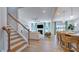 Open-concept living area with modern staircase, hardwood floors, and a cozy fireplace at 100 Cloud Berry Ln, Holly Springs, NC 27540