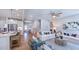 Bright living room with staircase, stylish furniture, and an open layout to the kitchen area at 100 Cloud Berry Ln, Holly Springs, NC 27540