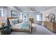 Serene main bedroom with tray ceilings and neutral decor, illuminated by multiple windows and lamps at 100 Cloud Berry Ln, Holly Springs, NC 27540