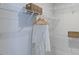 Well-organized walk-in closet with white wire shelving, hanging robe, and woven storage baskets at 100 Cloud Berry Ln, Holly Springs, NC 27540