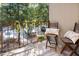 Cozy balcony featuring outdoor seating with a view of the parking area and lush trees at 108 Ephesus Church Rd # 510, Chapel Hill, NC 27517