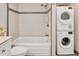 Modern bathroom featuring bathtub, shower and a stacked washer and dryer at 108 Ephesus Church Rd # 510, Chapel Hill, NC 27517