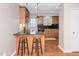 Kitchen features granite countertops, black backsplash, breakfast bar, and wooden cabinets with stainless appliances at 108 Ephesus Church Rd # 510, Chapel Hill, NC 27517