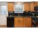 Kitchen features stainless appliances, granite countertops, wood cabinetry, and a black backsplash at 108 Ephesus Church Rd # 510, Chapel Hill, NC 27517