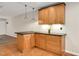 Bright kitchenette featuring wood cabinets, granite countertops, and modern pendant lighting at 108 Ephesus Church Rd # 510, Chapel Hill, NC 27517