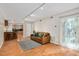 Open concept living space features wood-look floors, modern lighting, and a door leading to a patio at 108 Ephesus Church Rd # 510, Chapel Hill, NC 27517