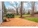 Large backyard with deck, privacy panel, and view of wooded lot at 1122 Shadyside Dr, Raleigh, NC 27612