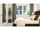 Bright bedroom featuring a large window, neutral tones and a lush potted plant at 1333 Hazelnut Ridge Ln, Knightdale, NC 27545