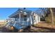 Exterior view of a charming light gray home featuring a covered porch and a well-maintained lawn at 1409 Mcdearman Ave, Rocky Mount, NC 27804