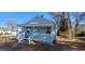Charming light gray home with a covered front porch, white railing, and steps at 1409 Mcdearman Ave, Rocky Mount, NC 27804