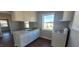 This kitchen features white cabinets and an oven and an eat-in area with a window overlooking the front yard at 1409 Mcdearman Ave, Rocky Mount, NC 27804