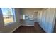 Eat-in kitchen featuring wood-look floors, bar seating, and ample storage at 1409 Mcdearman Ave, Rocky Mount, NC 27804
