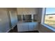 The kitchen features white cabinets and an eat-in area with a window looking out into the yard at 1409 Mcdearman Ave, Rocky Mount, NC 27804