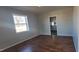 Living room with wood floors, a large window, and neutral paint at 1409 Mcdearman Ave, Rocky Mount, NC 27804
