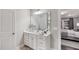 Modern bathroom with a white vanity, a large mirror, and stylish fixtures at 1702 Red Roses Ave, Durham, NC 27703