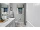 Clean bathroom featuring a vanity, a window, and a shower with black and white accents at 1702 Red Roses Ave, Durham, NC 27703