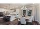 Stylish open concept kitchen with stainless appliances, island seating, and views into the dining space at 1702 Red Roses Ave, Durham, NC 27703