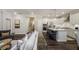 Modern open-concept kitchen featuring stainless steel appliances, a large island with bar seating, and white cabinetry at 1702 Red Roses Ave, Durham, NC 27703