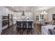 Contemporary kitchen with stainless steel appliances, a central island with bar seating, and an adjacent dining area at 1702 Red Roses Ave, Durham, NC 27703
