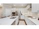 Well-lit kitchen with white cabinetry, stainless steel appliances, and a functional island for meal preparation at 1702 Red Roses Ave, Durham, NC 27703