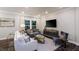Cozy living room with modern furniture, a large window, recessed lighting, and stylish decor at 1702 Red Roses Ave, Durham, NC 27703