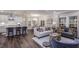 Open-concept living space with kitchen island, dining area, and stylish furnishings for comfortable living at 1702 Red Roses Ave, Durham, NC 27703