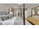 Spacious bedroom with a four-poster bed, tray ceiling, stylish decor, and neutral tones at 1702 Red Roses Ave, Durham, NC 27703