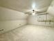 Large attic space with neutral carpet, white beadboard ceiling, and built-in shelving for storage at 1809 Waddill Way, Henderson, NC 27536