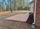 The backyard has a classic brick patio adjacent to the beautiful and lush landscaping at 1809 Waddill Way, Henderson, NC 27536