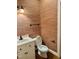 Charming half bath with unique wallpaper, traditional fixtures, and modern vanity at 1809 Waddill Way, Henderson, NC 27536