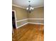 Spacious dining room featuring hardwood flooring and stylish light fixture at 1809 Waddill Way, Henderson, NC 27536
