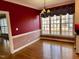 Bright dining room featuring hardwood floors, large windows and an elegant chandelier at 1809 Waddill Way, Henderson, NC 27536