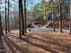 A long, winding driveway leads to a house nestled among mature trees at 1809 Waddill Way, Henderson, NC 27536