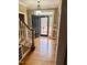 Welcoming entryway with hardwood floors, staircase, modern lighting, and front door with sidelights at 1809 Waddill Way, Henderson, NC 27536
