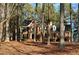 Traditional brick home with manicured landscaping and mature trees on the front lawn at 1809 Waddill Way, Henderson, NC 27536