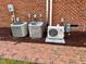 Home exterior with brick wall, multiple AC units, and other utilities, showcasing modern systems at 1809 Waddill Way, Henderson, NC 27536