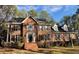 Beautiful brick home featuring manicured landscaping and traditional architectural details at 1809 Waddill Way, Henderson, NC 27536