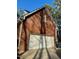 Attached two-car garage with white door and brick siding at 1809 Waddill Way, Henderson, NC 27536