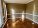Bright living room with hardwood floors and natural light from large windows at 1809 Waddill Way, Henderson, NC 27536