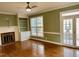 Cozy living room features built-in shelves, a fireplace, bright windows and exterior doors at 1809 Waddill Way, Henderson, NC 27536
