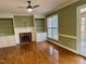 Inviting living room features built-in shelves, fireplace, and bright windows at 1809 Waddill Way, Henderson, NC 27536