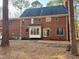 Brick home back exterior featuring an enclosed sunroom and patio at 1809 Waddill Way, Henderson, NC 27536