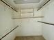 Walk-in closet with wooden shelving and neutral carpet at 1809 Waddill Way, Henderson, NC 27536