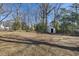 Spacious backyard with mature trees and a shed at 2207 Chautauqua Ave, Durham, NC 27707