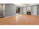 Inviting living room with fireplace, built-in shelving, wood floors, and sliding glass door to backyard at 230 Finley Forest Dr, Chapel Hill, NC 27517